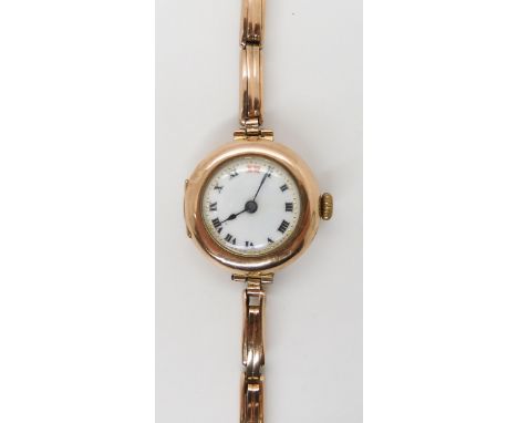 A 9ct gold ladies vintage watch with yellow metal strap, case London import marks for 1918, weight including mechanism and st