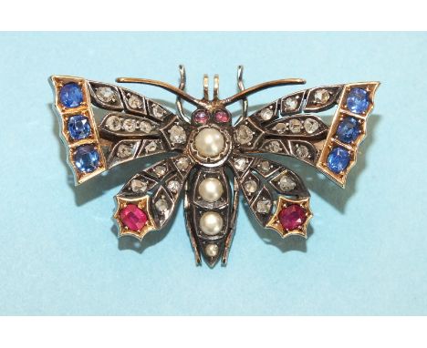 A late Victorian diamond, sapphire, ruby and pearl set butterfly brooch, the thorax and abdomen set graduated split pearls be