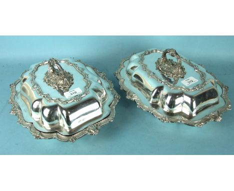 A pair of Victorian silver plated entrée dishes and covers of lobed form with scroll decoration and engine turned rims by W &