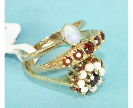 A five stone garnet 9ct gold ring, size O 1/2, a 9ct gold opal and garnet cluster ring, size N and a small 9ct gold ring set 