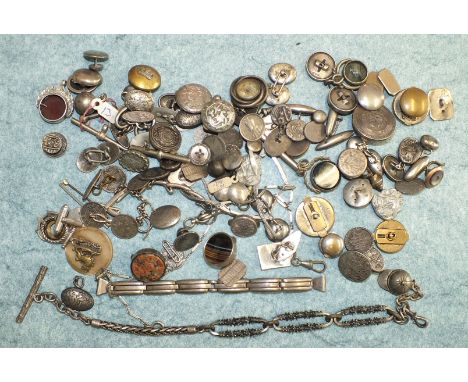 A compass fob in the form of a jockey's cap on plated metal watch chain and a quantity of cufflinks, studs, ec.