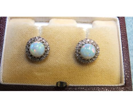 A pair of opal and diamond cluster earrings, each round opal within a surround of sixteen 8/8 cut diamond points on unmarked 