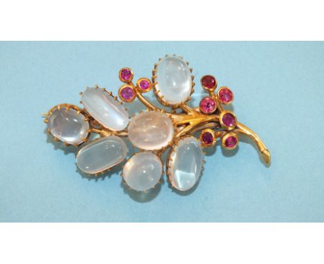A moonstone and ruby spray brooch, claw set seven moonstones and nine collet set rubies in unmarked yellow gold mount, 5cm lo