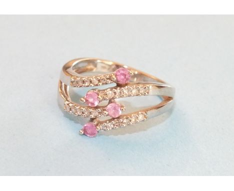 A 9ct white gold ring of four interwoven strands set diamond points with ruby terminals, size L, 3g.