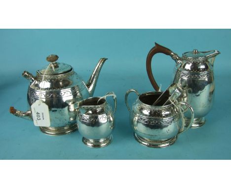 A Liberty & Co. four-piece tea service of rounded form, with embossed decoration, on beaded circular feet and a pair of sugar