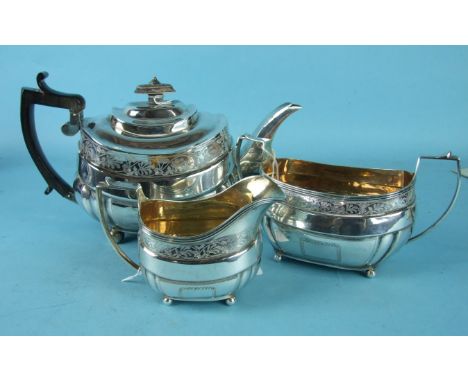 A George III three-piece tea service of rectangular form with a band of foliate cut decoration, on ball feet, London 1813-14,