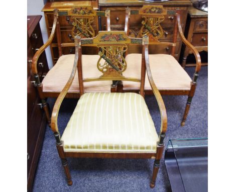 Three painted satinwood regency style open arm chairs, lyre shaped splat decorated with arrows and trumpet.