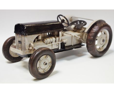 A tinplate Massey Ferguson System tractor possibly Jayland, grey body, black hood, chassis, seat &amp; steering wheel, metal 