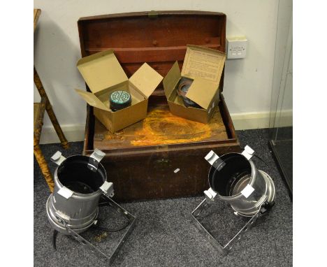 An early 20th century metal trunk; another smaller; a pair of stage lamps; two gas masks (6)
