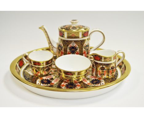 An Royal Crown Derby 1128 Imari pattern miniature tea set on tray, teacup, teapot, sugar bowl and cream jug (some boxes)