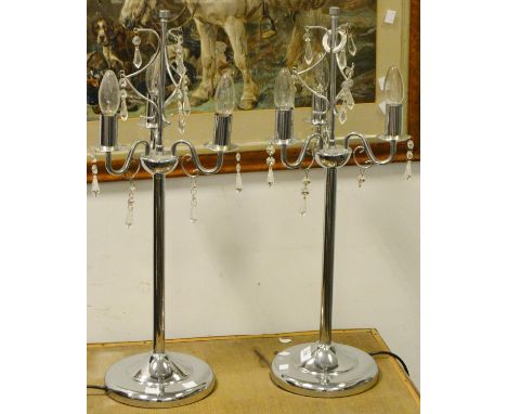 A pair of contemporary chrome three branch lamp bases with cut glass droplets and shades (2)