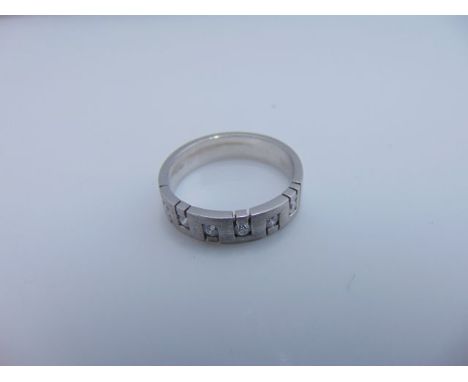 A diamond ring, centred with a brushed geometric section set with six round brilliant-cut diamonds weighing approximately 0.3