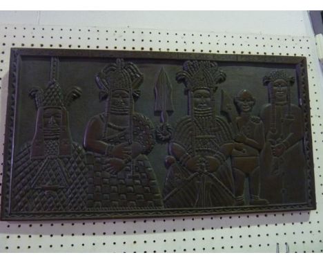 A Beninese (Nigerian) carved timber panel of rectangular form depicting three Obas, presented facing forward in traditional B