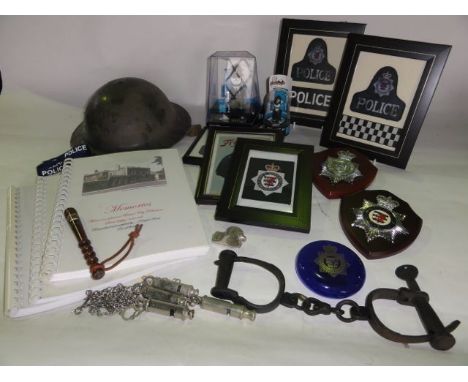 A box containing a selection of effects relating to the police including vintage shackles, a tin helmet, framed and glazed em