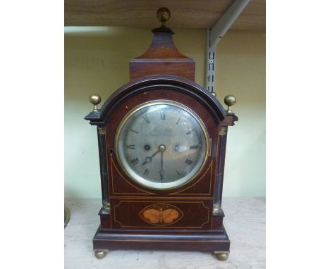 An Edwardian mahogany bracket clock in the Georgian style, the case with string inlaid detail and with butterfly marquetry pa