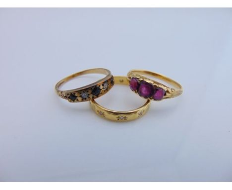 A sapphire and diamond ring, set with three round mixed-cut untested sapphires, interspersed with two single-cut diamonds, in