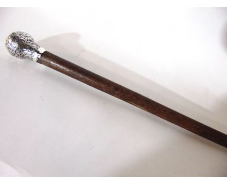 A timber walking stick terminating in a silver knop handle with embossed scrolling foliate detail (AF), hallmarked for London