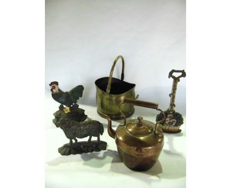 Three cast iron door porters of varying design, one in the form of a ram, together with a copper kettle and a brass coal helm