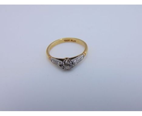 A solitaire diamond ring, claw-set with a round brilliant-cut diamond weighing approximately 0.17cts, in 18ct gold and platin