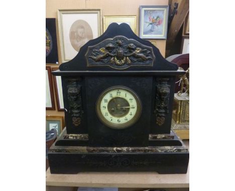 A substantial Victorian black slate and marble mantle clock with applied brass panel and eight day striking movement