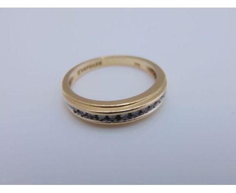 A half-eternity diamond ring, set with eleven round brilliant-cut diamonds, in 14ct white and yellow gold, inner band stamped