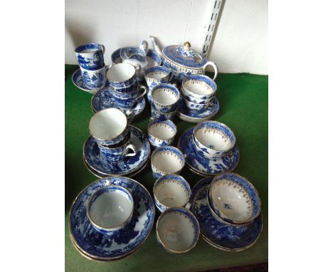 A mixed collection of early 19th century blue and white printed tea wares with chinoiserie decoration including teapot and co