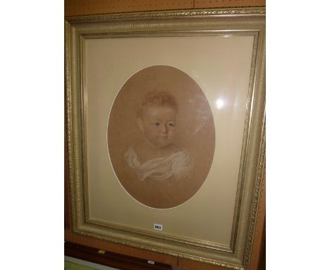 A 19th century pastel portrait of oval form showing a shoulder length study of  a baby, signed bottom right J Gilbert and dat