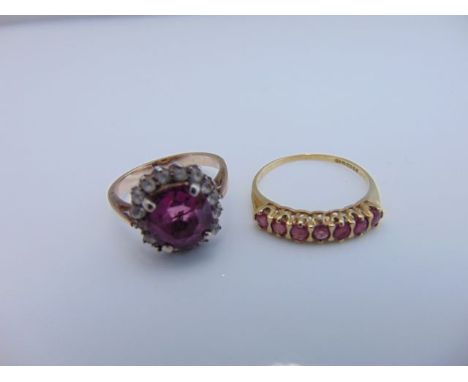 A ruby ring, set with seven round untested rubies, in 9ct gold, size Q; and a paste-set ring, the central pink stone within a