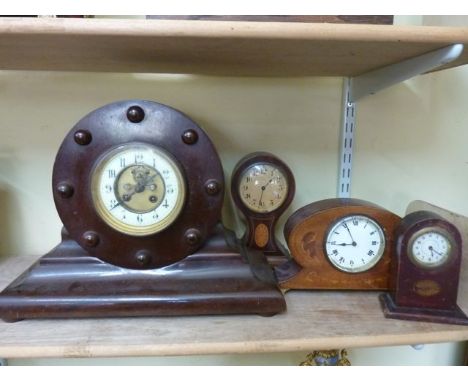 Four timber cased clocks including an example with simulated propellor hub case work, an inlaid Edwardian mantle clock with e