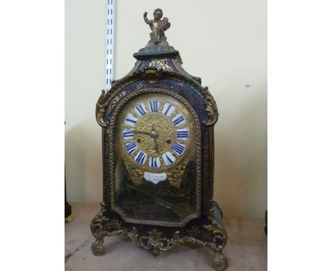 An early 19th century French bracket clock with boulle work case inlaid with brassware, overlaid with ormolu mounts, the dial