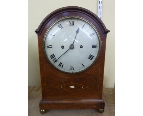 A late 19th century mahogany bracket clock, the mahogany case with string banded inlay with arched outline enclosing a convex