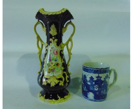 A large 18th century tankard with blue and white painted chinoiserie decoration with double reeded entwined handles with leaf