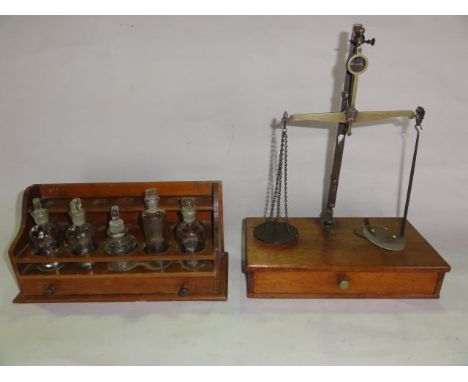 A vintage brass framed set of apothecary scales with a single draw timber base together with a laboratory/chemists test tube/