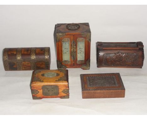 A small Chinese timber bank of three drawers set before a pair of hinged doors with pierced jadeite panelling,  further appli