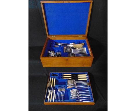 A 20th century oak canteen containing a quantity of mostly electroplated cutlery over two tiers by Daniel & Arter to include 