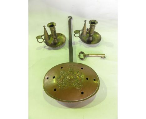 A 19th century pierced copper chestnut roaster with embossed coat of arms detail with an applied iron handle together with a 