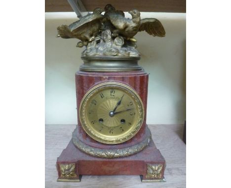 A 19th century French mantle clock, the eight day striking movement set within a fluted column set on a platform base with gi