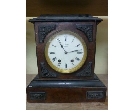 A late 19th century walnut mantle clock, the case with applied detail enclosing a two train movement with enamelled dial by L