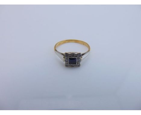 A sapphire and diamond ring, centred with a square-cut untested sapphire, the bezel highlighted with eight single-cut diamond