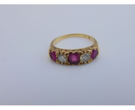 An Edwardian style ruby and diamond ring, centred with an untested oval mixed-cut ruby weighing approximately 0.49cts, flanke