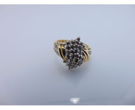 A diamond cluster ring, the domed setting highlighted with round brilliant-cut diamonds, in 14ct gold, size M