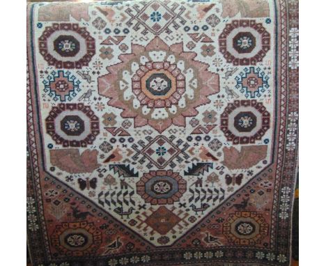 A Persian style wool carpet with multi-medallion centre upon a white field within running borders 160 x 100 cm approx