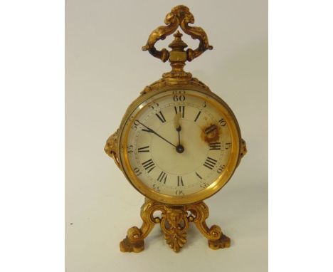 A 19th century gilded brass mantle clock, the circular case with lion mask mounts raised on shaped and pierced base with axe 