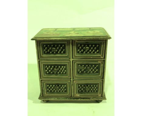 A miniature Indian painted timber cabinet of six matched drawers, each panel fronted with bordered and painted floral detail 