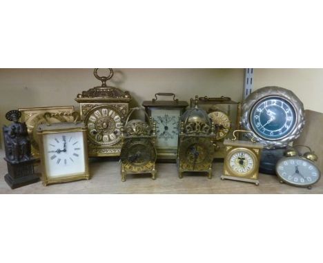 A mixed collection of small brass and other mantle clocks including reproduction lantern clock, carriage clocks, etc