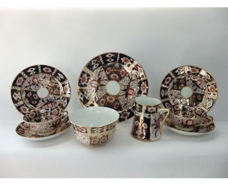 A collection of tea wares in the Royal Crown Derby manner with painted and gilded Imari type decoration comprising cake plate