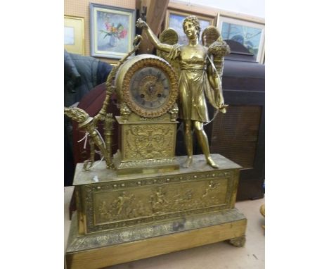 An early 19th century French mantle clock with cast and gilded brass case, classical motifs including flame torch, bow, quive