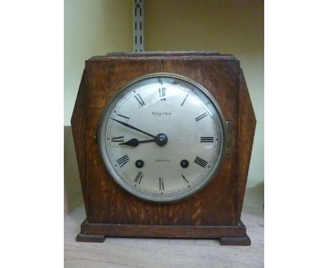 An Art Deco oak cased mantle clock enclosing a two train movement retailed by Mappin & Webb