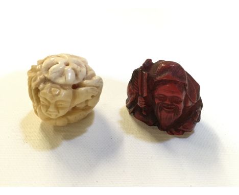Two netsuke 35 mm the red being resin and the white carved bone.