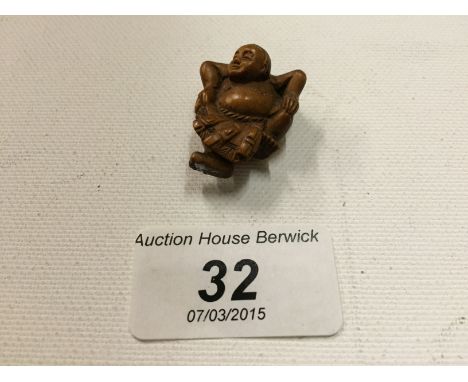 A small netsuke of a man dancing 30 mm.